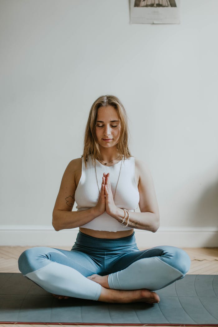 who-we-are A serene image of a woman practicing meditation indoors, promoting mindfulness and wellbeing.